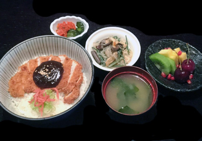 Cotoletta di suino con salsa di miso  su una ciotola di riso